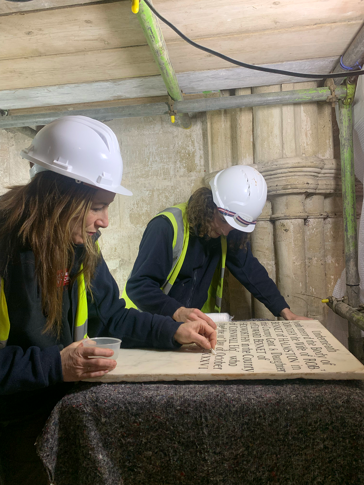 Stonemasons, Anna and Joe, cleaning the monument